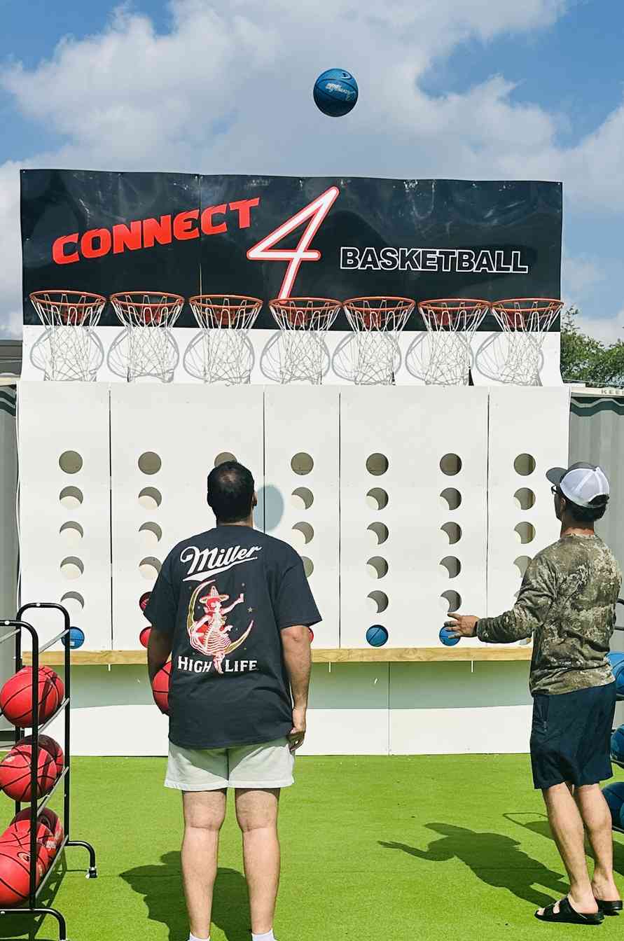 Players competing at the Connect 4 Basketball game at Trick Shot X